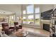 Living room with a fireplace and large windows with a view of the pond at 180 Oakhurst Way, Westfield, IN 46074
