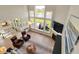 Open living room with large windows, fireplace, comfortable seating, and views of the backyard at 180 Oakhurst Way, Westfield, IN 46074