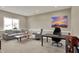 Neutral living room with sofa, armchair, modern art, and a large window at 180 Oakhurst Way, Westfield, IN 46074