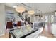 Open concept living space featuring modern lighting, staircase, and views of the dining room and kitchen at 180 Oakhurst Way, Westfield, IN 46074
