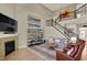 Spacious living room with high ceilings, a stone fireplace, and staircase at 180 Oakhurst Way, Westfield, IN 46074