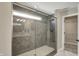 Glass enclosed walk-in shower boasts unique gray, herringbone tiling and a built-in seat at 180 Oakhurst Way, Westfield, IN 46074