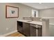 Finished basement wet bar features quartz countertops, stainless steel appliances and an accent wall at 180 Oakhurst Way, Westfield, IN 46074