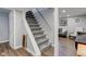 Basement staircase leading to finished living space with plush carpet and painted white railing at 1865 N Norfolk St, Indianapolis, IN 46224