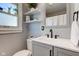Bright bathroom features a stylish vanity, floating shelves, and updated fixtures at 1865 N Norfolk St, Indianapolis, IN 46224