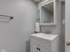 Compact bathroom with a modern vanity, mirrored cabinet, and neutral wall color at 1865 N Norfolk St, Indianapolis, IN 46224