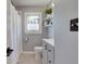 Bathroom featuring a shower, black and white tile, and white vanity at 1865 N Norfolk St, Indianapolis, IN 46224