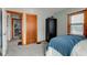 Bedroom featuring hardwood doors, plush carpet, and closet at 1865 N Norfolk St, Indianapolis, IN 46224