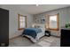 Cozy bedroom with neutral walls, plush carpet, and natural light at 1865 N Norfolk St, Indianapolis, IN 46224