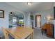 Open-concept dining room with living room, piano, and bathroom views at 1865 N Norfolk St, Indianapolis, IN 46224