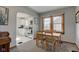 Charming dining room with wood table and view into kitchen at 1865 N Norfolk St, Indianapolis, IN 46224