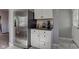 Well-lit kitchen featuring stainless steel refrigerator and white cabinets at 1865 N Norfolk St, Indianapolis, IN 46224
