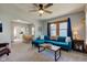Comfortable living room with modern decor, blue sofa, and ceiling fan at 1865 N Norfolk St, Indianapolis, IN 46224