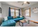 Inviting living room with large windows, stylish blue sofa, and natural light at 1865 N Norfolk St, Indianapolis, IN 46224