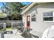 Spacious back deck featuring a table and grill, with a view of the backyard, rear door, privacy fence, and trees at 207 S Arlington Ave, Indianapolis, IN 46219