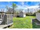Spacious backyard featuring a deck, storage shed and a well-maintained lawn at 207 S Arlington Ave, Indianapolis, IN 46219