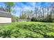 Expansive backyard with lush greenery, mature trees and an outdoor storage shed at 207 S Arlington Ave, Indianapolis, IN 46219
