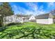 A verdant backyard includes a grassy lawn, shade trees and multiple storage sheds at 207 S Arlington Ave, Indianapolis, IN 46219