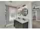 Updated bathroom featuring double sinks, wood accents, updated lighting, and modern fixtures at 207 S Arlington Ave, Indianapolis, IN 46219