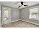 Comfortable bedroom with ceiling fan and an adjacent bathroom featuring tile floors at 207 S Arlington Ave, Indianapolis, IN 46219