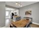 Open concept dining room and kitchen boasts modern lighting and stainless steel appliances at 207 S Arlington Ave, Indianapolis, IN 46219