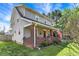 Charming two-story home featuring a front porch with red brick columns and an American flag at 207 S Arlington Ave, Indianapolis, IN 46219