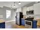 Well-lit kitchen featuring stainless steel appliances and butcher block countertops at 207 S Arlington Ave, Indianapolis, IN 46219
