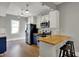 Stylish kitchen features white cabinets, butcher block countertops and stainless steel appliances at 207 S Arlington Ave, Indianapolis, IN 46219