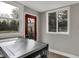 Bright laundry room with ample windows and a red exterior door leading to the backyard at 207 S Arlington Ave, Indianapolis, IN 46219