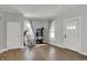 Bright living room with hardwood floors, two large windows, and fresh white trim and paint at 207 S Arlington Ave, Indianapolis, IN 46219