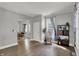Bright living room features hardwood floors and neutral paint with a glimpse into the dining room at 207 S Arlington Ave, Indianapolis, IN 46219