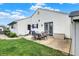Backyard patio with outdoor seating, white siding on home, and green grass at 20777 Summitt Rd, Noblesville, IN 46062
