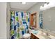 Bathroom featuring a whale themed shower curtain, sink, and wooden trim at 20777 Summitt Rd, Noblesville, IN 46062