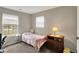 Bedroom featuring two windows, carpeted floors, and an end table with lamp at 20777 Summitt Rd, Noblesville, IN 46062