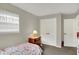 Well-lit bedroom with a large window, double closet, and carpeted floors at 20777 Summitt Rd, Noblesville, IN 46062