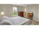 Relaxing bedroom with a soft gray bedspread, matching curtains, and classic wooden furniture at 20777 Summitt Rd, Noblesville, IN 46062