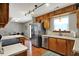 Kitchen with wooden cabinetry, stainless steel appliances, and an open layout to the dining area at 20777 Summitt Rd, Noblesville, IN 46062