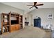 Inviting living room with vaulted ceilings, plush carpeting, and a built-in wooden entertainment center at 20777 Summitt Rd, Noblesville, IN 46062