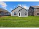 New home backyard features a large lawn and gray siding at 2276 Marjorie Way, Shelbyville, IN 46176