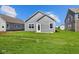 Backyard shows a green lawn and gray siding on the back of a new house at 2276 Marjorie Way, Shelbyville, IN 46176