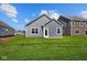 New home backyard featuring a large lawn and gray siding at 2276 Marjorie Way, Shelbyville, IN 46176
