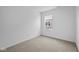 Neutral carpeted bedroom with a window looking out to a neighboring house at 2276 Marjorie Way, Shelbyville, IN 46176