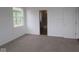Spacious carpeted bedroom featuring a closet and an ensuite bathroom at 2276 Marjorie Way, Shelbyville, IN 46176