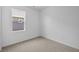 Bedroom features neutral carpet, a window with horizontal blinds, and white walls at 2276 Marjorie Way, Shelbyville, IN 46176