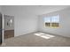 Well lit bedroom with neutral carpeting and views of the outdoors from the window at 2276 Marjorie Way, Shelbyville, IN 46176