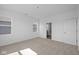 Bright bedroom featuring neutral colors, carpeting, and doorways to a bathroom and hallway at 2276 Marjorie Way, Shelbyville, IN 46176