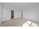 A bright bedroom with neutral walls, carpeting, and doors to a closet and hallway at 2276 Marjorie Way, Shelbyville, IN 46176