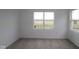 Bright, carpeted bedroom with two large windows offering natural light and outdoor views at 2276 Marjorie Way, Shelbyville, IN 46176