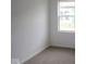 Carpeted bedroom with natural light streaming through a large window and neutral wall colors at 2276 Marjorie Way, Shelbyville, IN 46176
