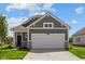 Charming single-Gathering home showcases a gray exterior, stone accents, and a spacious two-car garage at 2276 Marjorie Way, Shelbyville, IN 46176